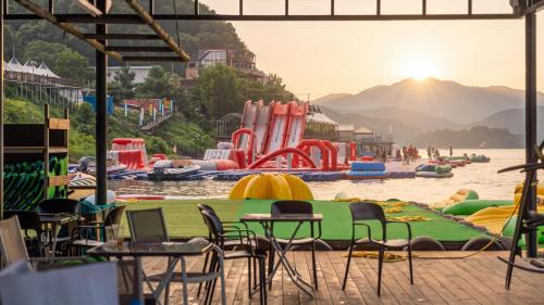 a group of tables and chairs in a water park at Gapyeong 516geullaemlaban in Gapyeong