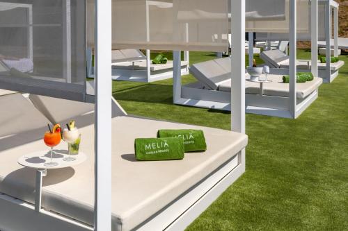 two views of a house with green grass at Meliá Lloret de Mar in Lloret de Mar