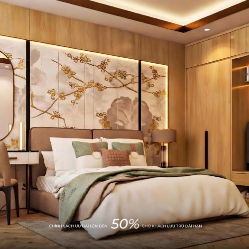 a bedroom with a bed with a large painting on the wall at Sala Lan Anh hotel in Phước Long