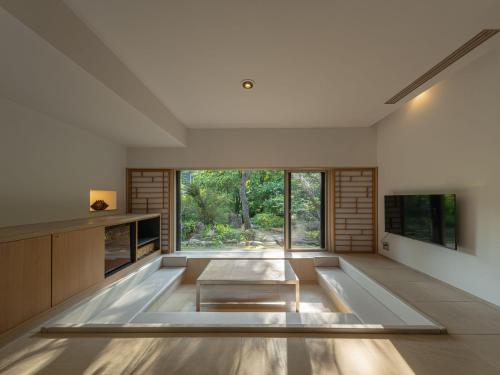 a room with a large window and a table at OTARU RETREAT KURAMURE by Onko Chishin in Otaru