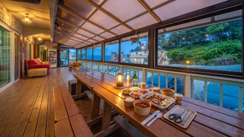 a dining room with a table with food on it at Goseong Araenmaru Pension in Goseong