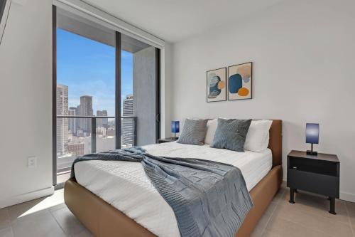 a bedroom with a bed and a large window at The York Suite Miami in Miami