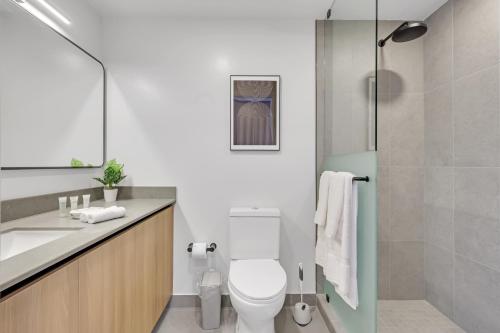 a bathroom with a toilet and a sink and a shower at The York Suite Miami in Miami