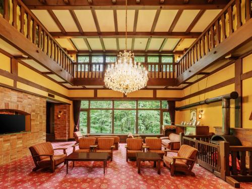 a large room with a chandelier and tables and chairs at Wan Wan Paradise Takayama in Takayama