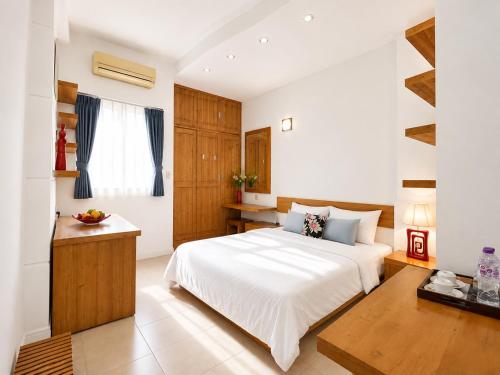 a bedroom with a large white bed and a window at Saigon Quiet Stay in Ho Chi Minh City