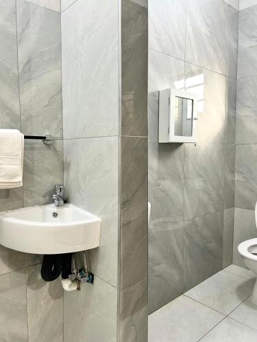 a bathroom with a sink and a toilet at Caysa Villa in Gaborone