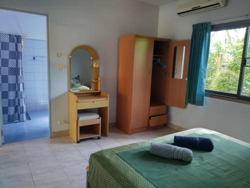 a bedroom with a bed and a sink and a mirror at Sabai Residence in Ao Nang Beach