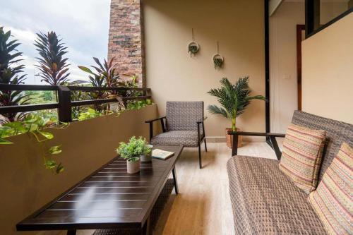 a living room with a couch and chairs on a balcony at Syrena Multi Listing in Playa del Carmen