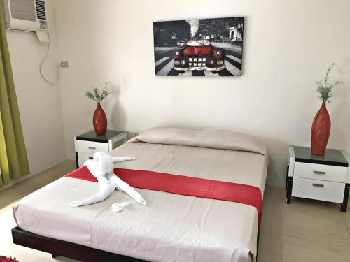 a bedroom with two beds and a car on the wall at Sioland Grand Premier Hotel Candelaria in Candelaria