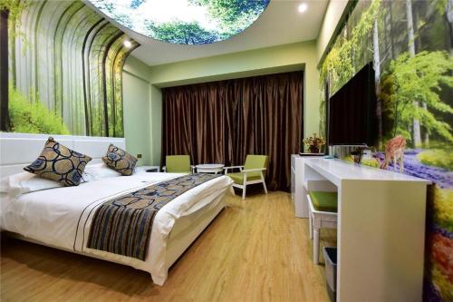 a bedroom with a bed and a table and a kitchen at Dali Dayu Hotel in Dali