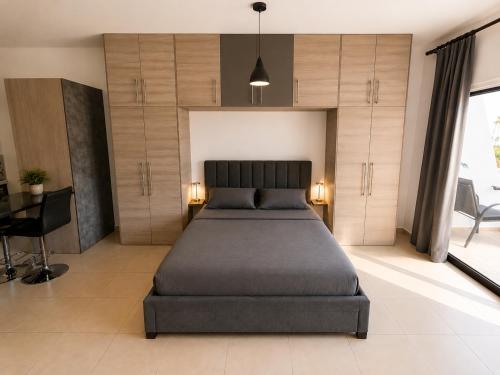 a bedroom with a bed and a desk in it at Maison Amalthea in Limassol