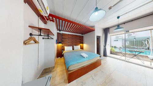a bedroom with a bed in a room with a pool at Z2 Boutique Hotel in Ban Samet