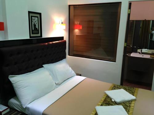 a bedroom with a bed and a sink in it at Zanrock Micro Hotel in Lagao III