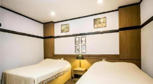 a room with two beds and a window in it at Numsin Hotel in Ban Rong Chang