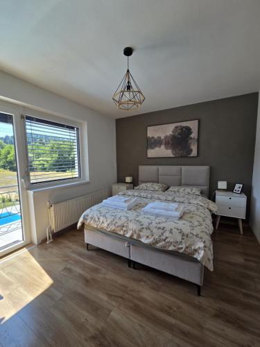 a bedroom with a bed and a large window at Under The Castle in Dob