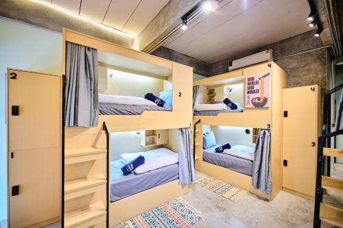 a group of bunk beds in a room at Noodle Shop Hostel in Nathon Bay