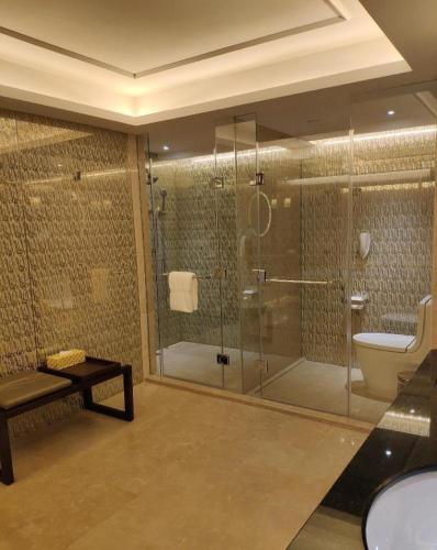 a bathroom with a glass shower and a toilet at Jai Alai Hotel in Macau