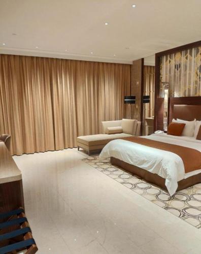 a large bedroom with a large bed and a couch at Jai Alai Hotel in Macau