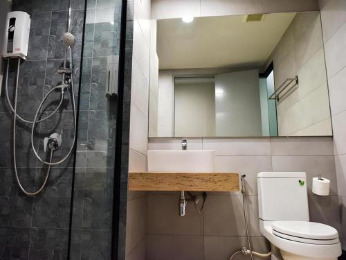 a bathroom with a shower and a toilet and a sink at @Sleep in Ban Rang Faet
