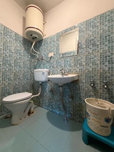 a bathroom with a toilet and a sink at City Star in Srinagar