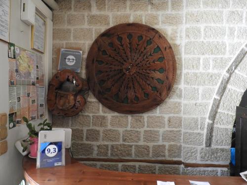 a wall with a wooden plaque on a brick wall at Konstantinou & Elenis in Monodendri