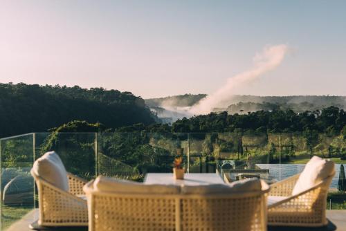 a table and chairs with a view of a mountain at Gran Meliá Iguazú in Puerto Iguazú