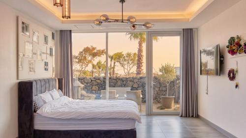 a bedroom with a bed and a large window at Seogwipo Dawa Pool Villa Pension in Seogwipo