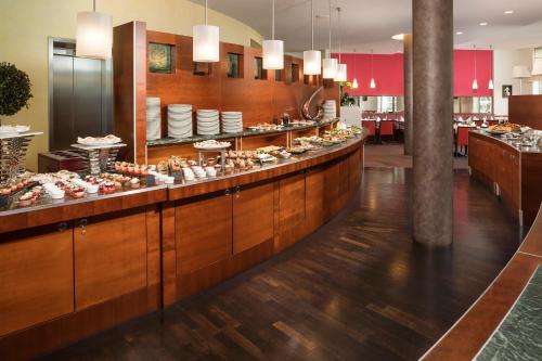 a buffet line in a restaurant with food at Meliá Berlin in Berlin