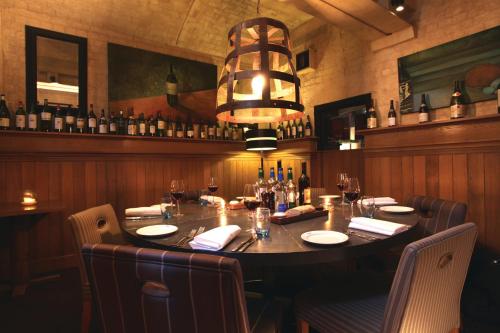 a dining room with a large table in a restaurant at Malmaison Oxford in Oxford
