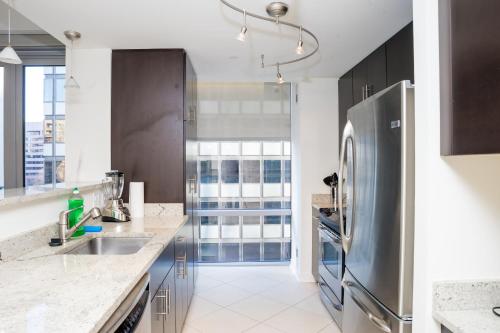 a kitchen with a stainless steel refrigerator at Arlington Fully Furnished Apartments in Crystal City in Arlington
