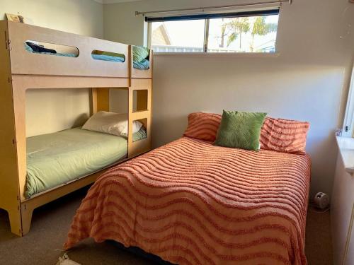 a bedroom with two bunk beds and a bed at Villa LaNoah in Kalbarri