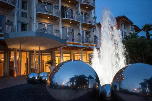 a water fountain in front of a building at Color Hotel Style, Design & Gourmet in Bardolino