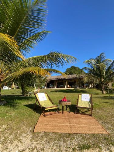 two chairs and a table in front of a house at Ankavia Lodge in Sainte Marie