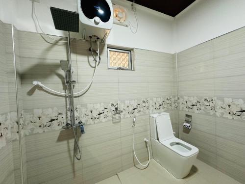 a bathroom with a toilet and a shower at Sigiriya Peacock Homestay in Sigiriya