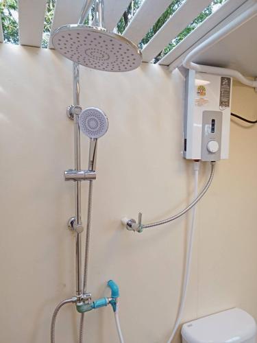 a bathroom with a shower and a toilet at Riverside Glamping Resort Kanchanaburi in Kanchanaburi City