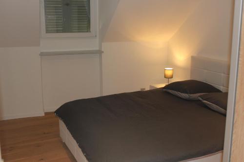 a bedroom with a bed and a lamp on a table at New appartment Design Montreux in Montreux