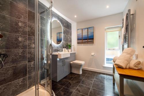 a bathroom with a shower and a sink at Warner - Treworgie Barton Cottages in Bude