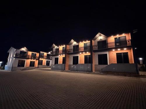 a large building with lights on it at night at Chanko's Cottages in Tsemi