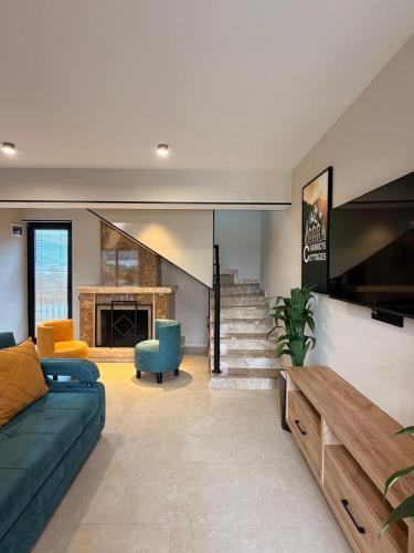 a living room with a couch and a fireplace at Chanko's Cottages in Tsemi