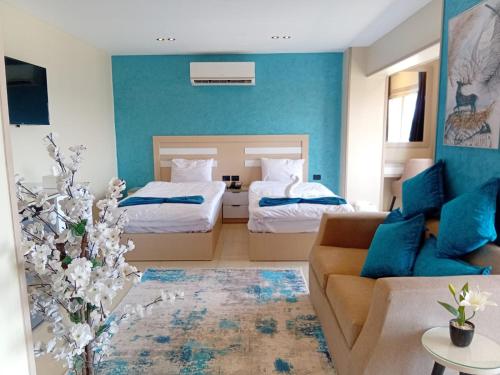 a living room with two beds and a couch at MIRA Holiday Home in Cairo
