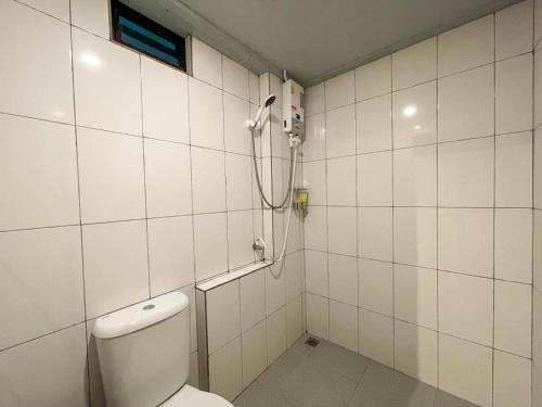 a bathroom with a toilet and a shower at Warehouse18 Pool Cafe Resort in Don Sak