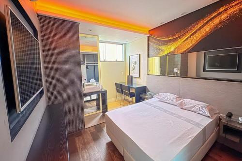 a bedroom with a bed and a bathroom with a sink at Style Hotel ( Adults Only) in São Paulo