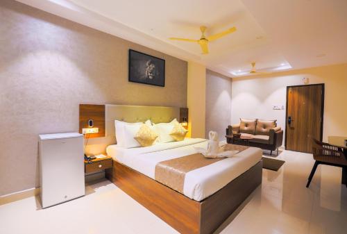 a hotel room with a bed and a chair at Rhyme Hotel - Hitech City in Hyderabad