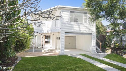 a white house with a garage at Whalesong in New Brighton