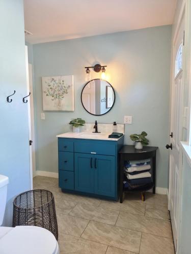 a bathroom with a blue sink and a mirror at Garden Clara in Yuba City