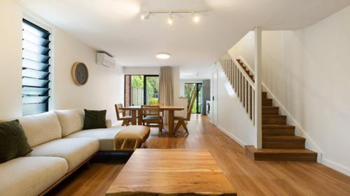 a living room with a couch and a table at Brunswick Palms 1 in Brunswick Heads