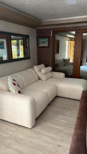 a living room with a white couch and a mirror at Vasilisa Luxury River House in Pančevo
