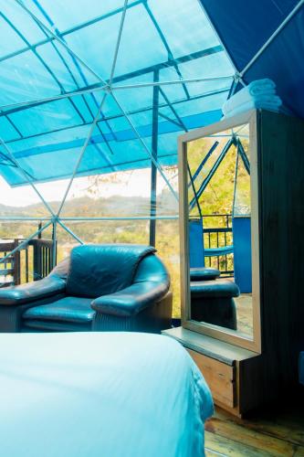a bedroom with a bed and a mirror in a tent at Villas del Rio Glamping in San Francisco