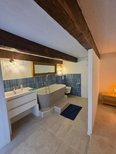 a large bathroom with a tub and a sink at Lavande in Beaumont-de-Pertuis