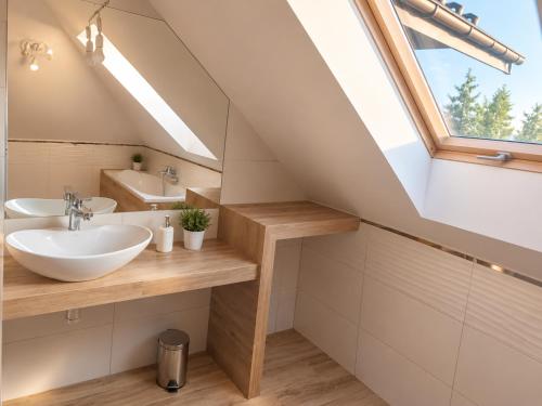 a bathroom with a sink and a window at Oko na Mogielice in Słopnice